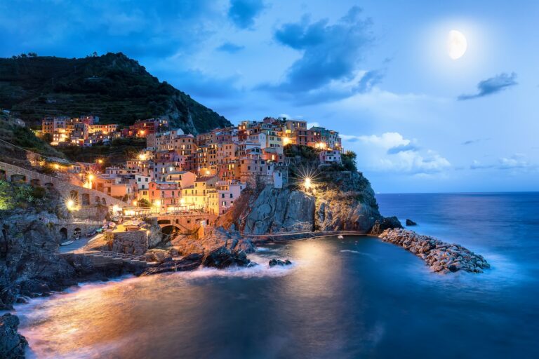 Blue moon and Manarola village at night, Cinque Terre, Italy, Europe